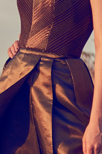 Portion of a green dress showing fabric detail